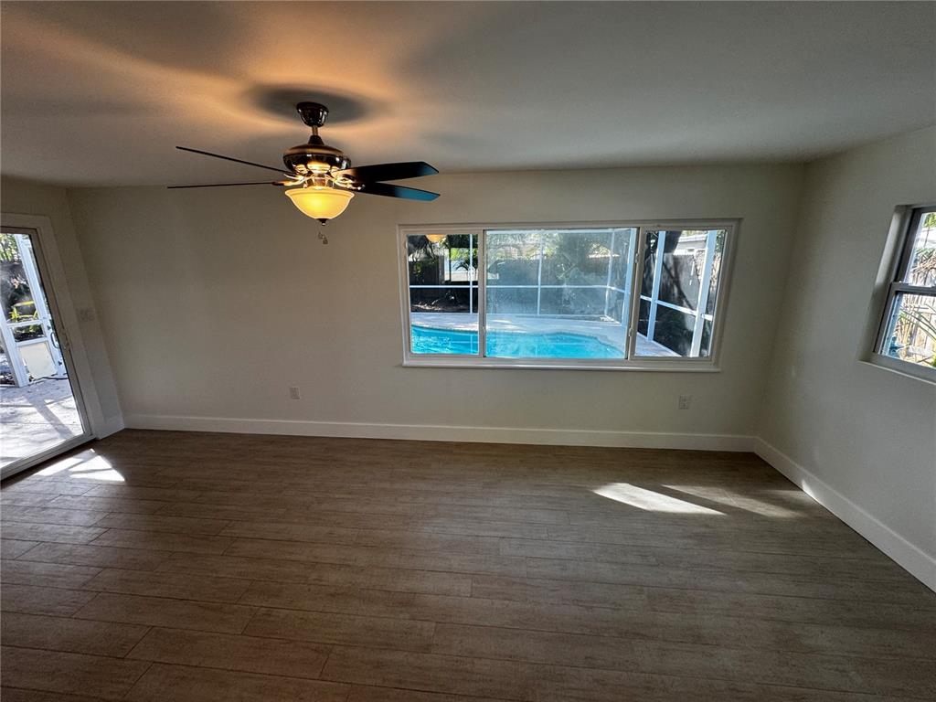 3182 Hatton Street Sarasota, FL 34237 - Photo 13 of 22 wooden floor in an empty room with a window