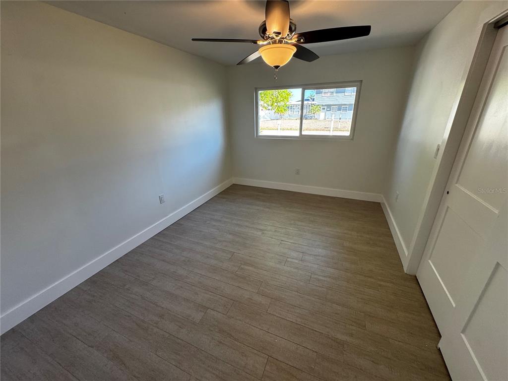 3182 Hatton Street Sarasota, FL 34237 - Photo 15 of 22 an empty room with windows and fan