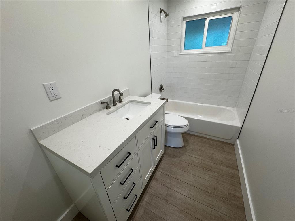 3182 Hatton Street Sarasota, FL 34237 - Photo 17 of 22 a bathroom with a double vanity sink toilet and a tub