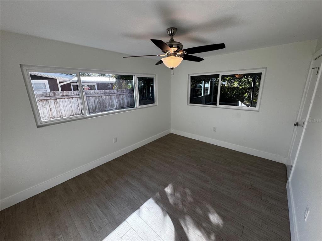 3182 Hatton Street Sarasota, FL 34237 - Photo 18 of 22 a view of an empty room with wooden floor and a window