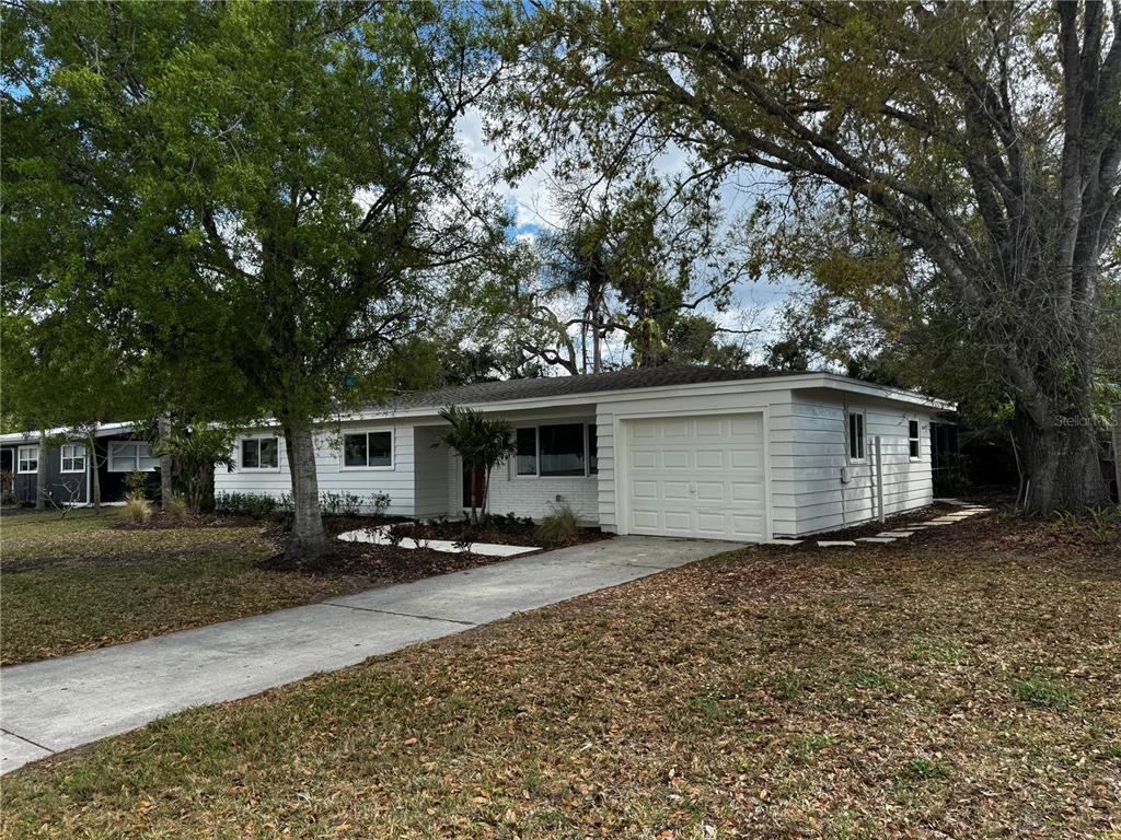 3182 Hatton Street Sarasota, FL 34237 - Photo 2 of 22 a front view of a house with a yard