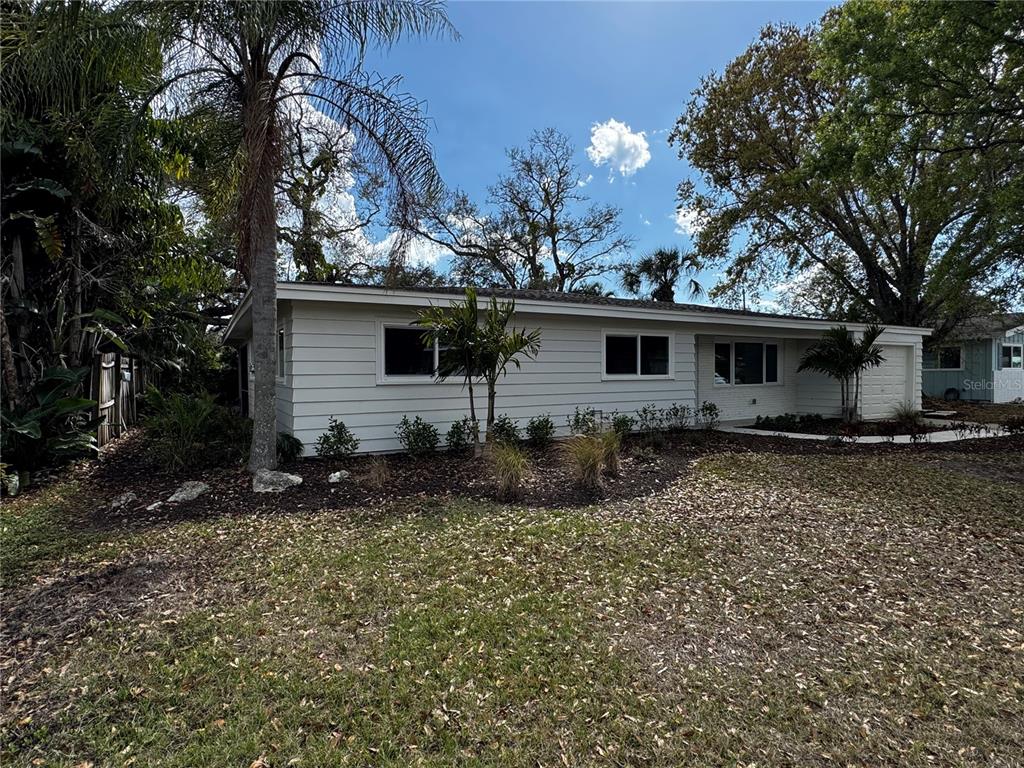 3182 Hatton Street Sarasota, FL 34237 - Photo 3 of 22 a front view of house with yard and trees