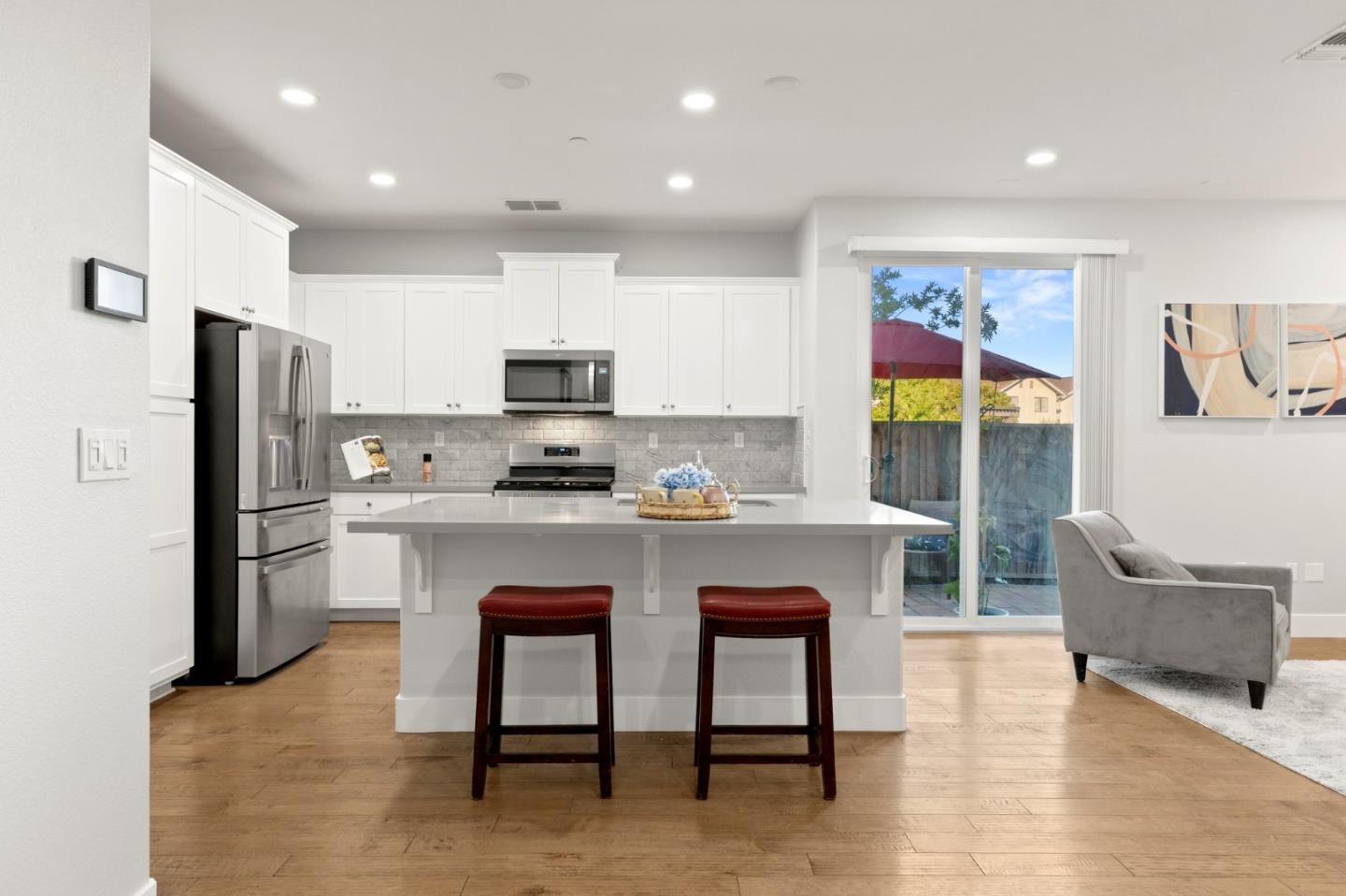 24253 Nora Circle Hayward, CA 94545 - Photo 5 of 49 a kitchen with stainless steel appliances granite countertop a refrigerator a sink a stove a dining table and chairs with wooden floor