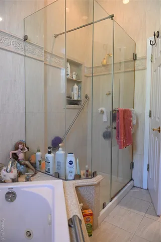 a bathroom with a granite countertop sink toilet a mirror and a window