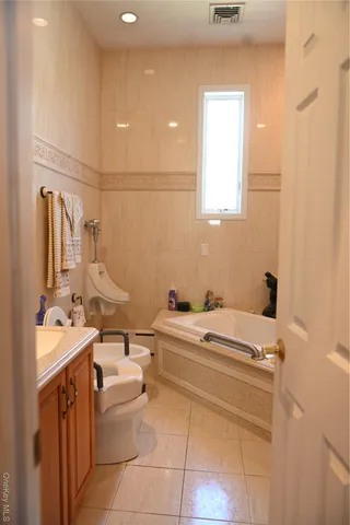 a bathroom with a sink a toilet and mirror