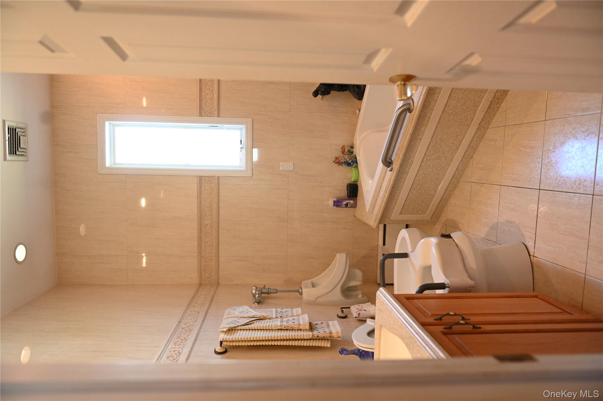 115 Riviera Drive Mastic Beach, NY 11951 - Photo 15 of 27 a bathroom with a sink a toilet and mirror