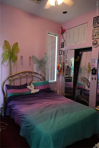 a bedroom with a bed dresser and a window