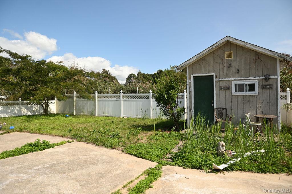 115 Riviera Drive Mastic Beach, NY 11951 - Photo 20 of 27 a front view of a house with garden