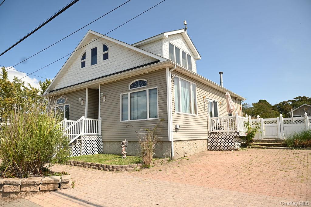 115 Riviera Drive Mastic Beach, NY 11951 - Photo 3 of 27 a front view of a house with a yard