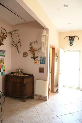 a living room with a bed and a refrigerator