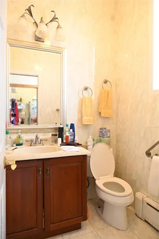 a bathroom with a toilet a sink and a mirror