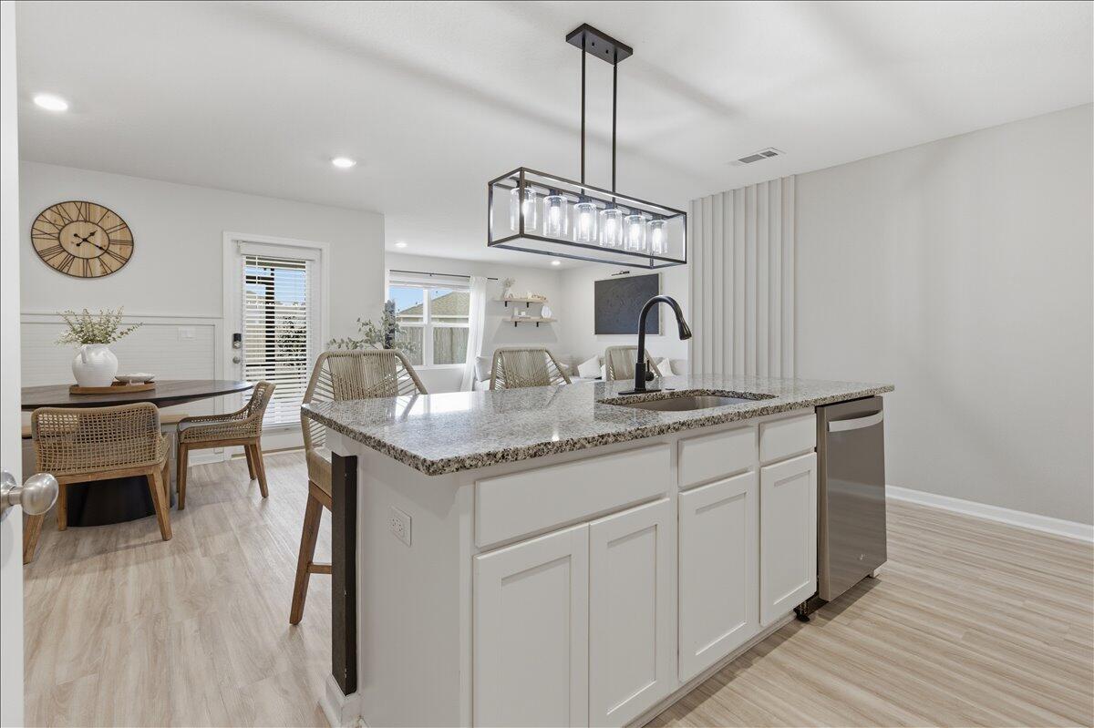943 Sandbar Loop Crestview, FL 32539 - Photo 23 of 59 a kitchen with granite countertop a sink cabinets and wooden floor