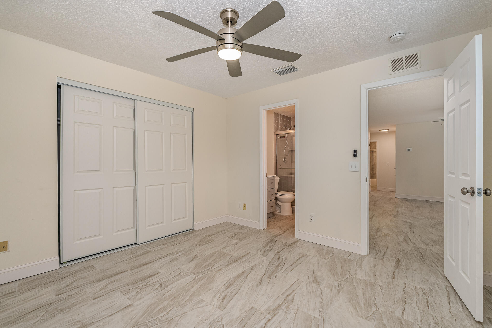 2896 Lancaster Road Melbourne, FL 32935 - Photo 15 of 25 an empty room with wooden floor and a ceiling fan