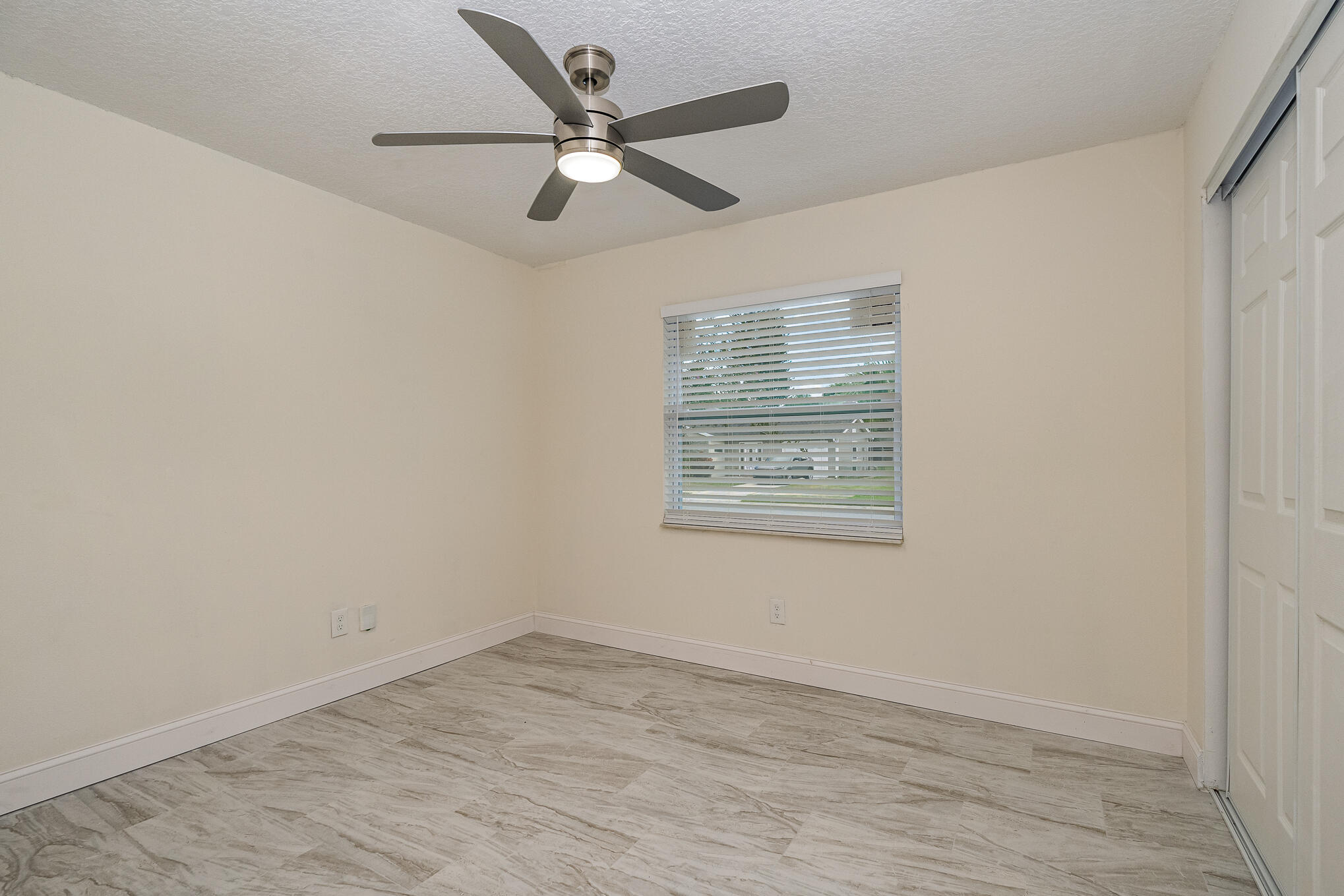 2896 Lancaster Road Melbourne, FL 32935 - Photo 19 of 25 an empty room with a window and ceiling fan