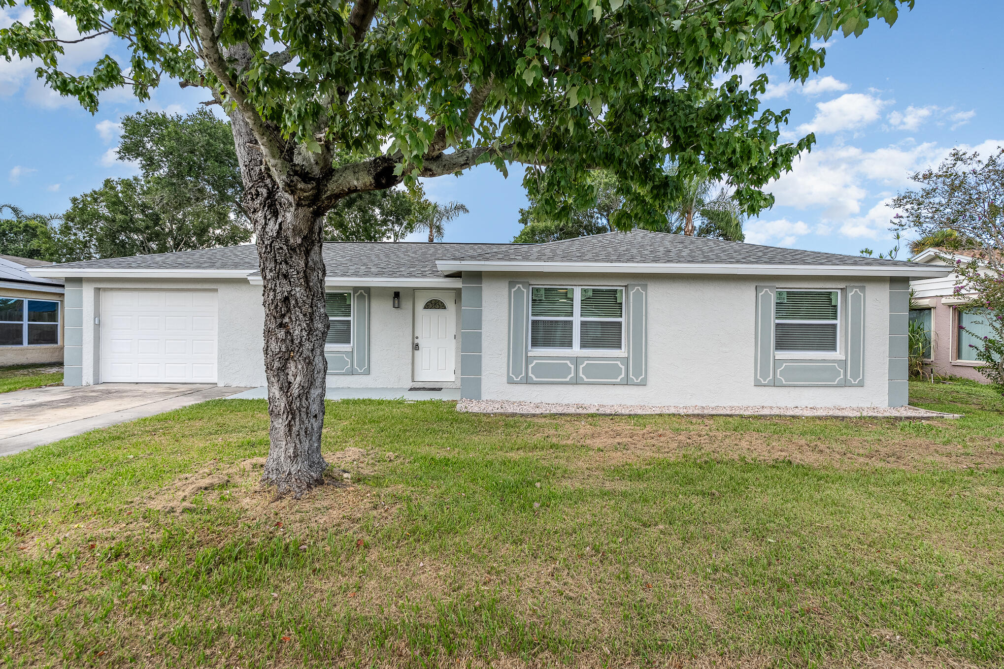 2896 Lancaster Road Melbourne, FL 32935 - Photo 4 of 25 a house with trees in the background