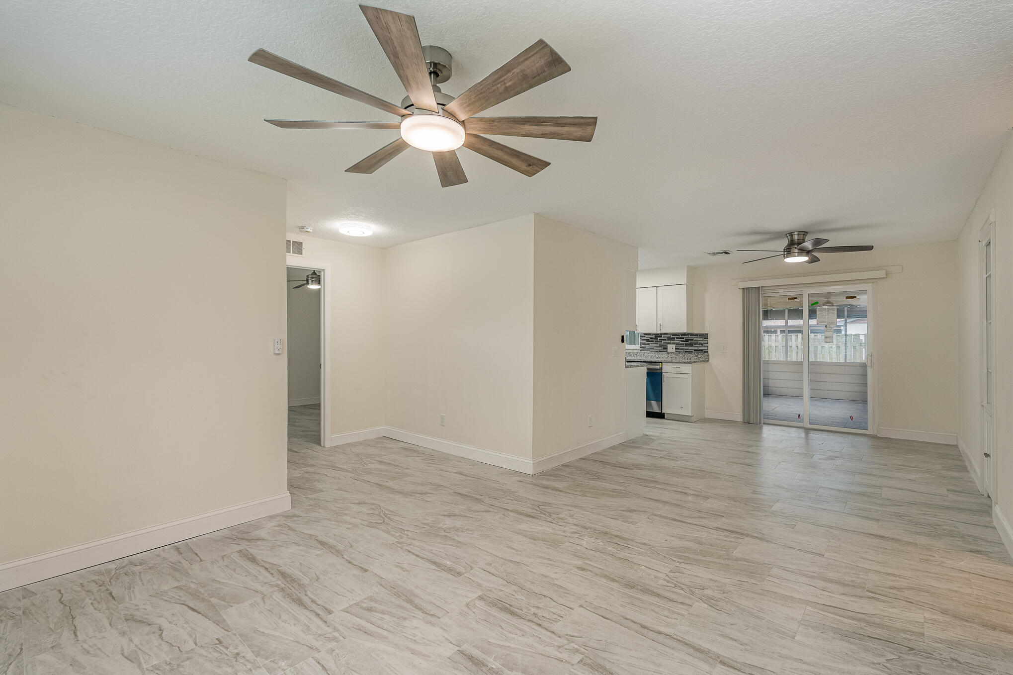 2896 Lancaster Road Melbourne, FL 32935 - Photo 9 of 25 a view of an empty room with kitchen and a window