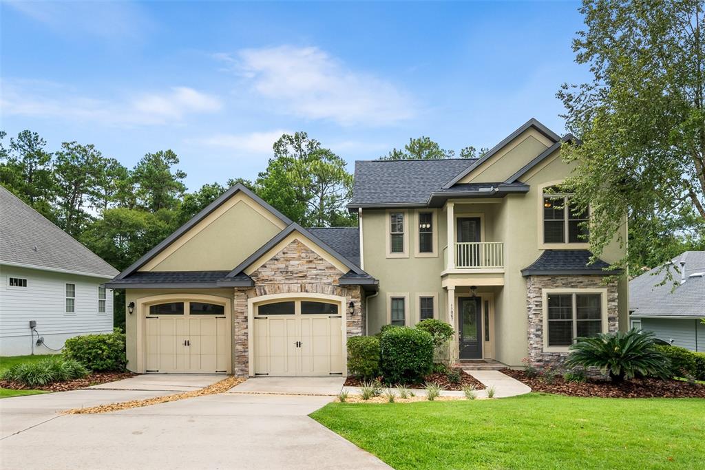 11067 Northwest 18th Road Gainesville, FL 32606 - Photo 1 of 58 a front view of a house with a yard and garage