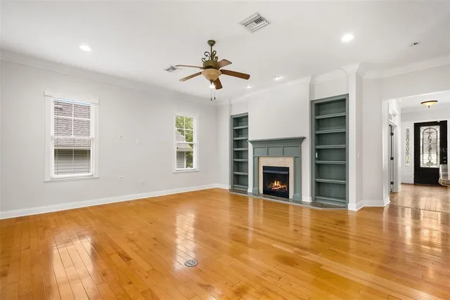 a view of a livingroom with a fireplace a chandelier and entryway