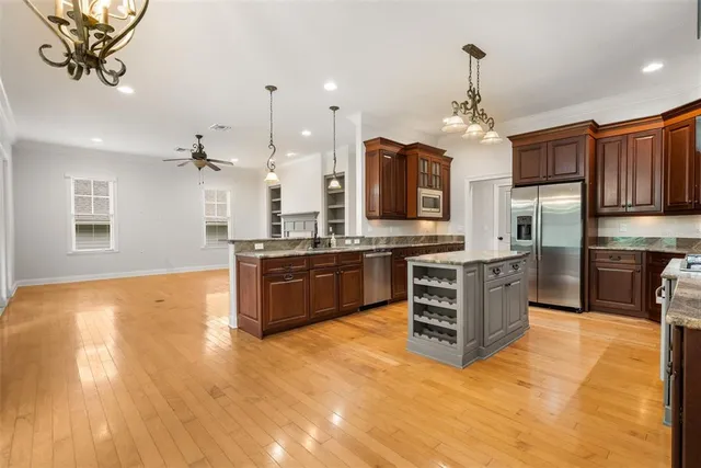 a kitchen with a stove a window and chairs