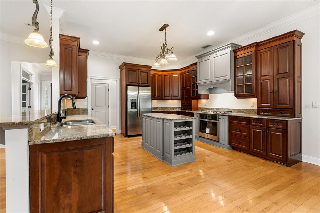 11067 Northwest 18th Road Gainesville, FL 32606 - Photo 25 of 58 a kitchen with stainless steel appliances kitchen island granite countertop a stove top oven and refrigerator