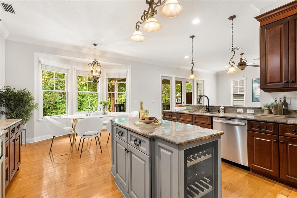 11067 Northwest 18th Road Gainesville, FL 32606 - Photo 26 of 58 a kitchen with a stove a window and chairs