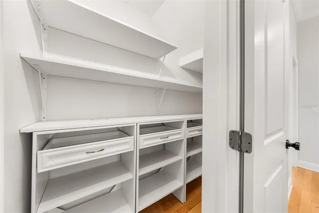 a view of an empty room and a ceiling fan