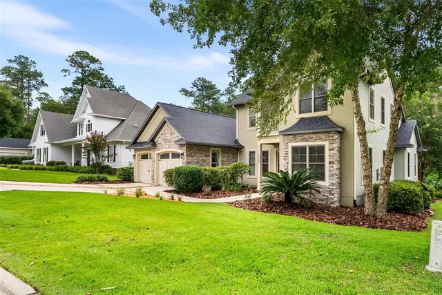 a front view of house with yard and green space