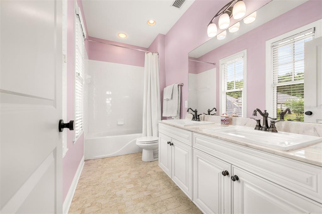 11067 Northwest 18th Road Gainesville, FL 32606 - Photo 43 of 58 a bathroom with a granite countertop sink mirror bathtub and toilet