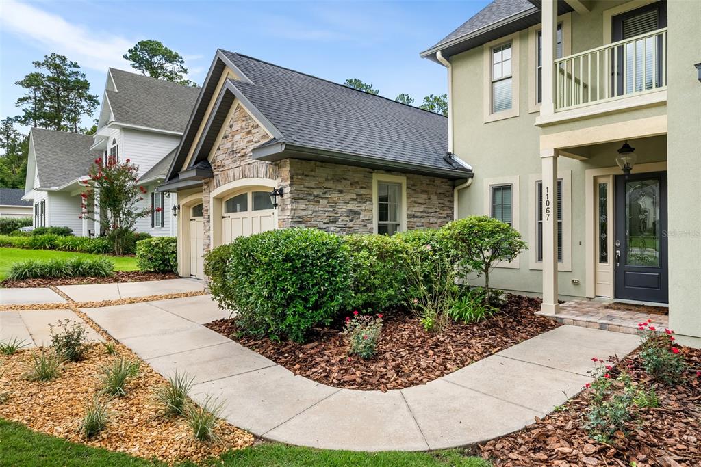 11067 Northwest 18th Road Gainesville, FL 32606 - Photo 6 of 58 front view of a house with a bench