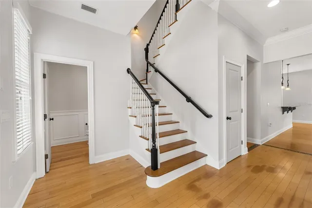 a view of entryway and hall with wooden floor
