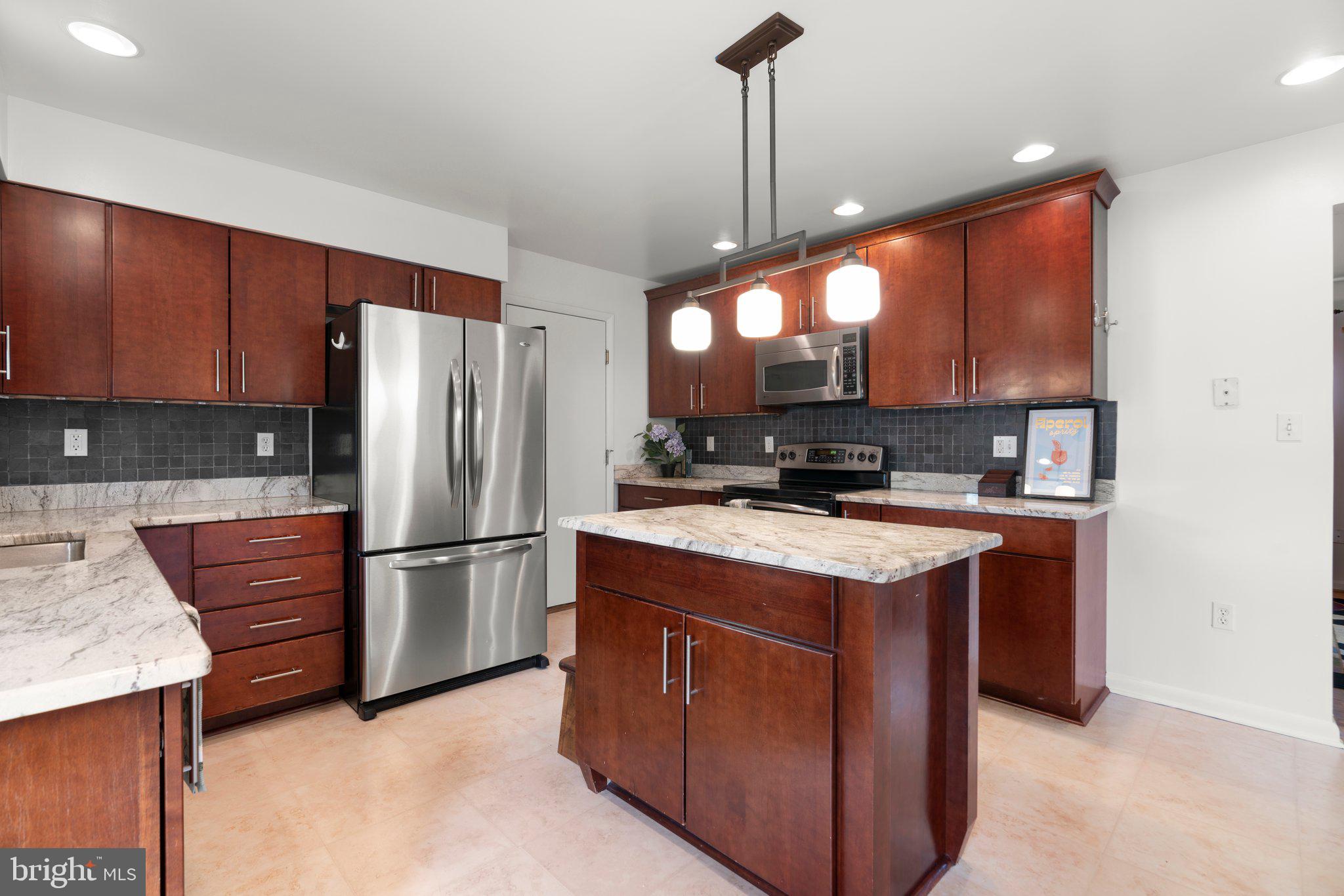 14816 Mistletoe Court Silver Spring, MD 20905 - Photo 11 of 44 a kitchen with stainless steel appliances granite countertop a stove a refrigerator a sink and a refrigerator