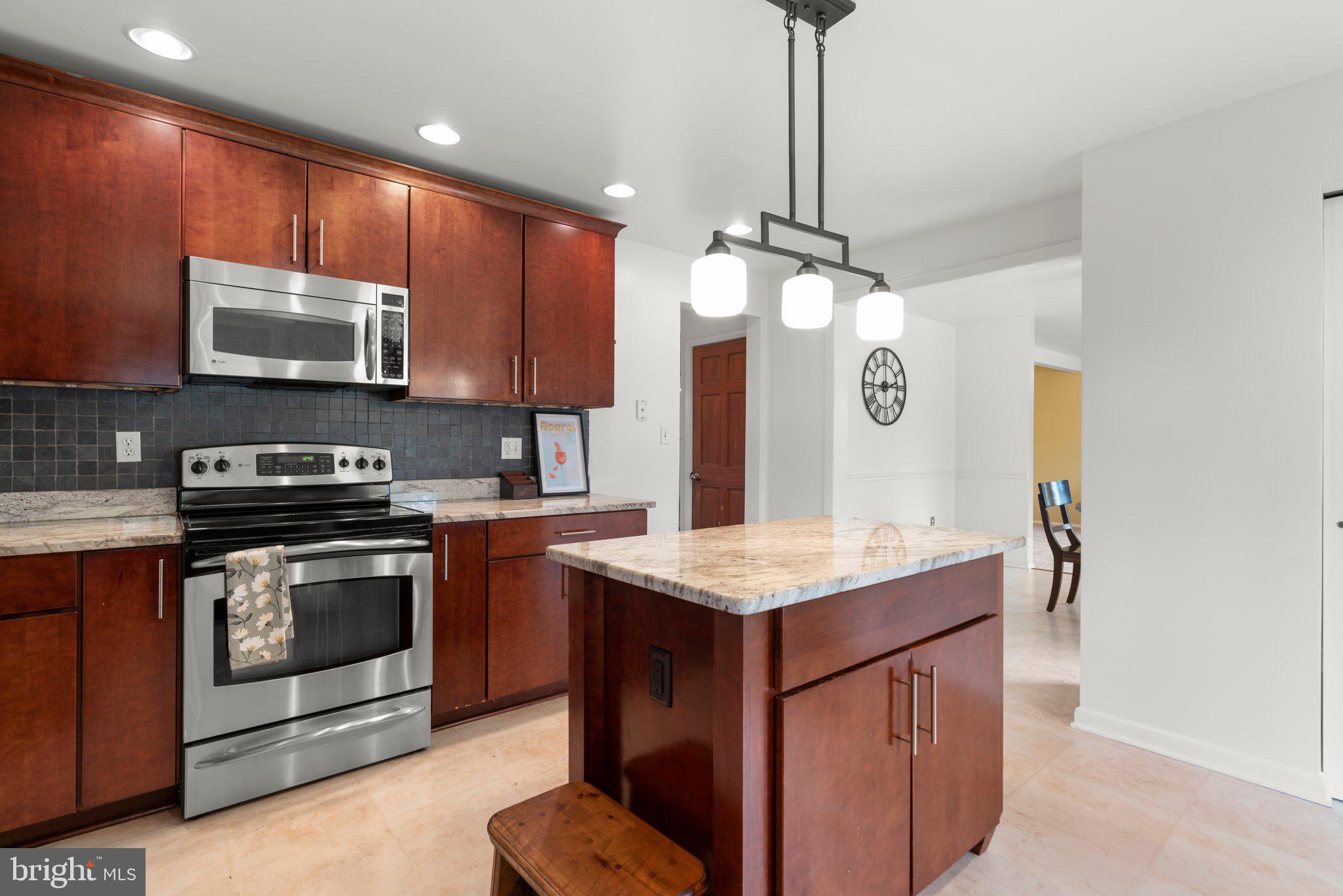 14816 Mistletoe Court Silver Spring, MD 20905 - Photo 12 of 44 a kitchen with stainless steel appliances granite countertop a stove a sink and a microwave