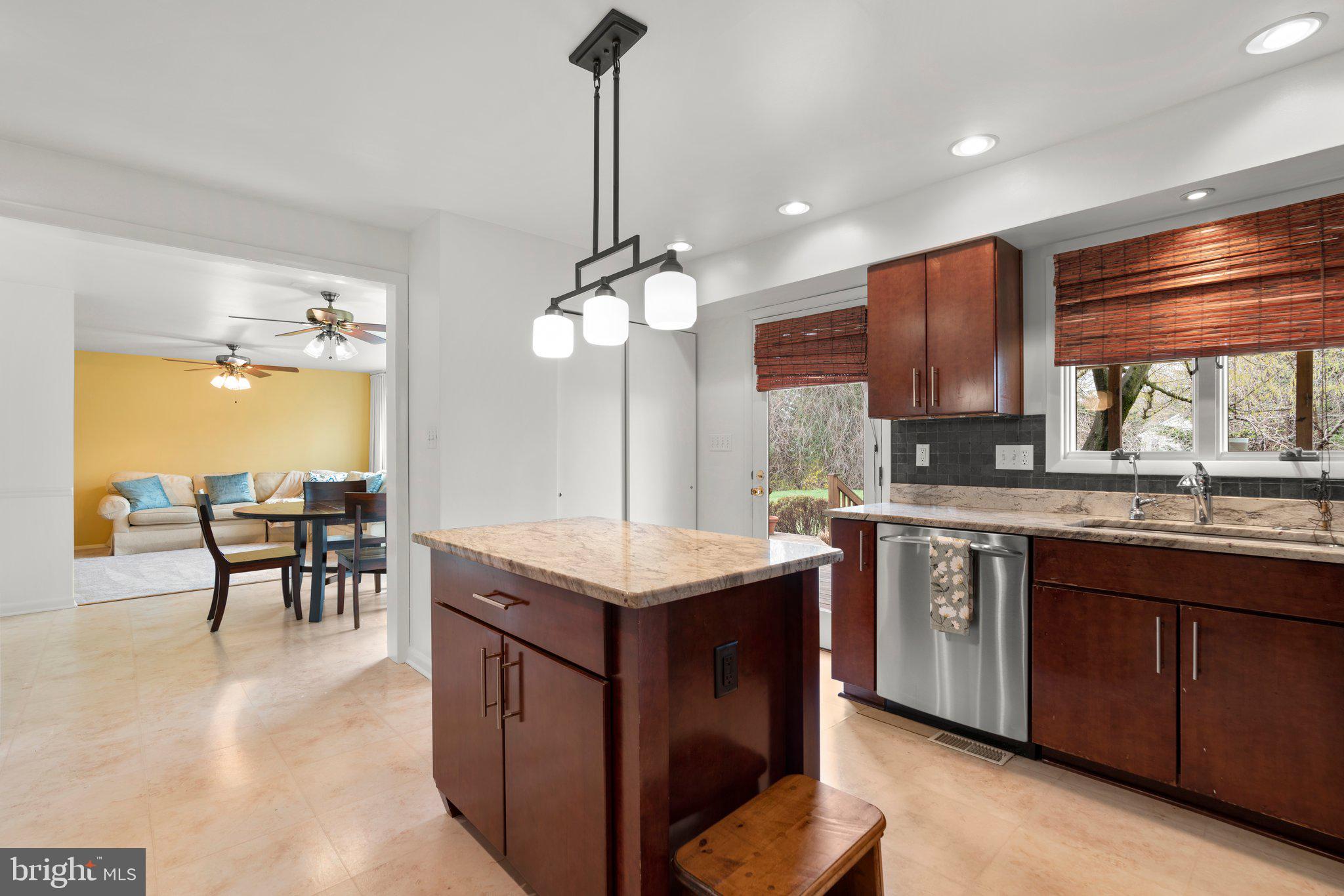 14816 Mistletoe Court Silver Spring, MD 20905 - Photo 13 of 44 a kitchen with kitchen island granite countertop a sink counter and chairs
