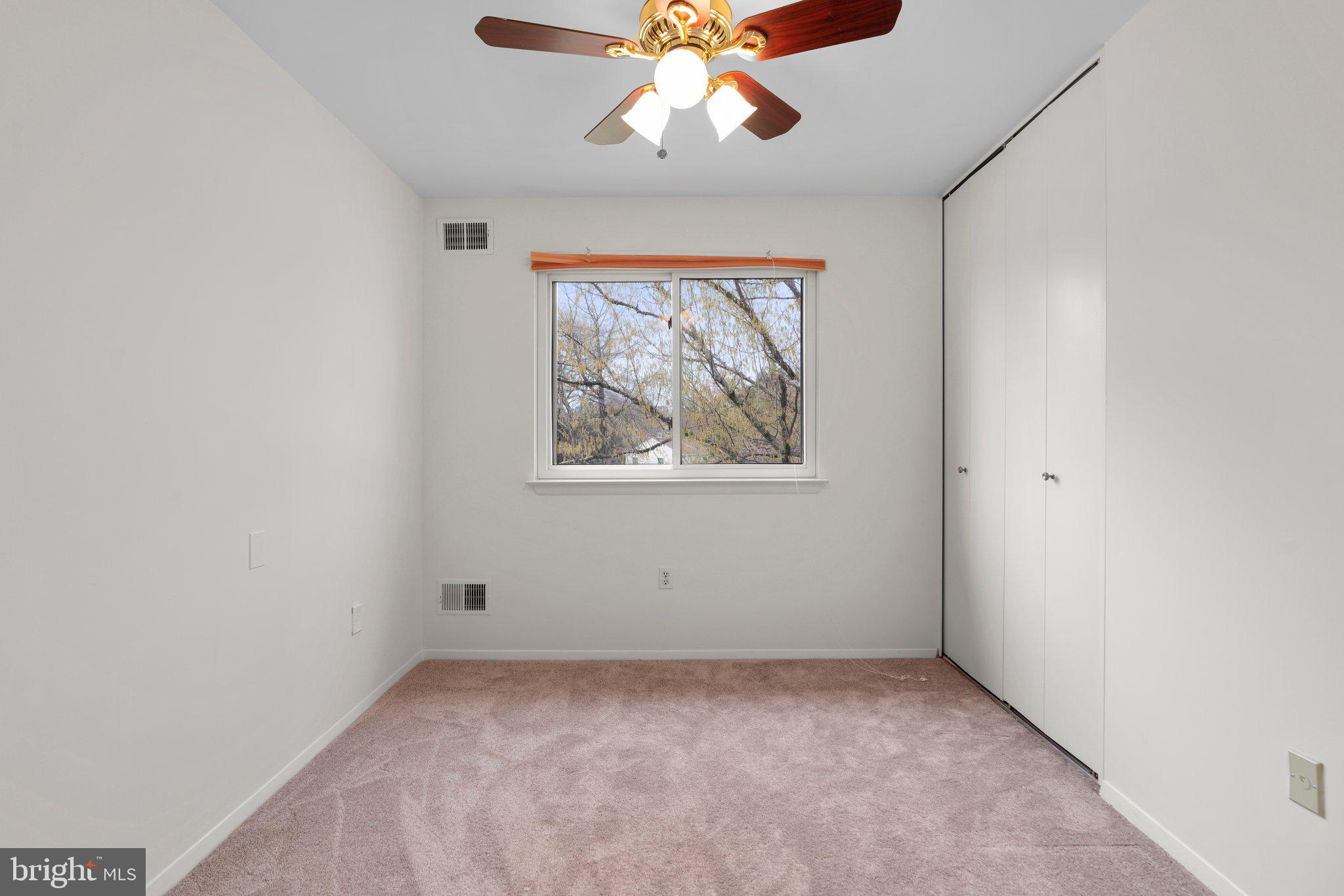 14816 Mistletoe Court Silver Spring, MD 20905 - Photo 21 of 44 an empty room with a window and a fan