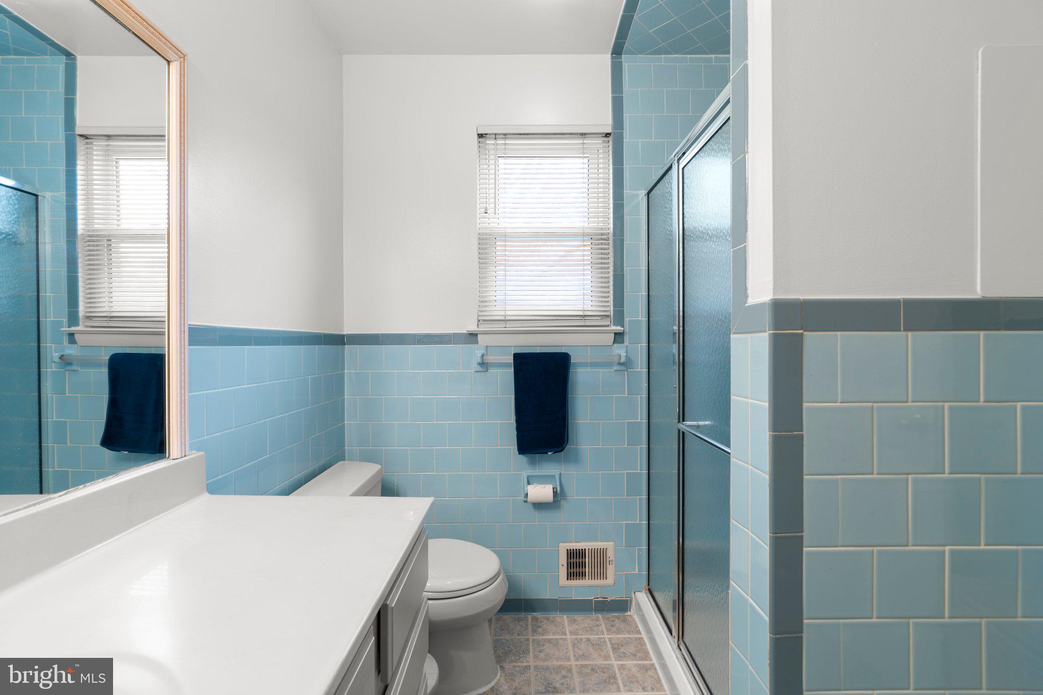 14816 Mistletoe Court Silver Spring, MD 20905 - Photo 29 of 44 a bathroom with a granite countertop toilet a sink and a mirror