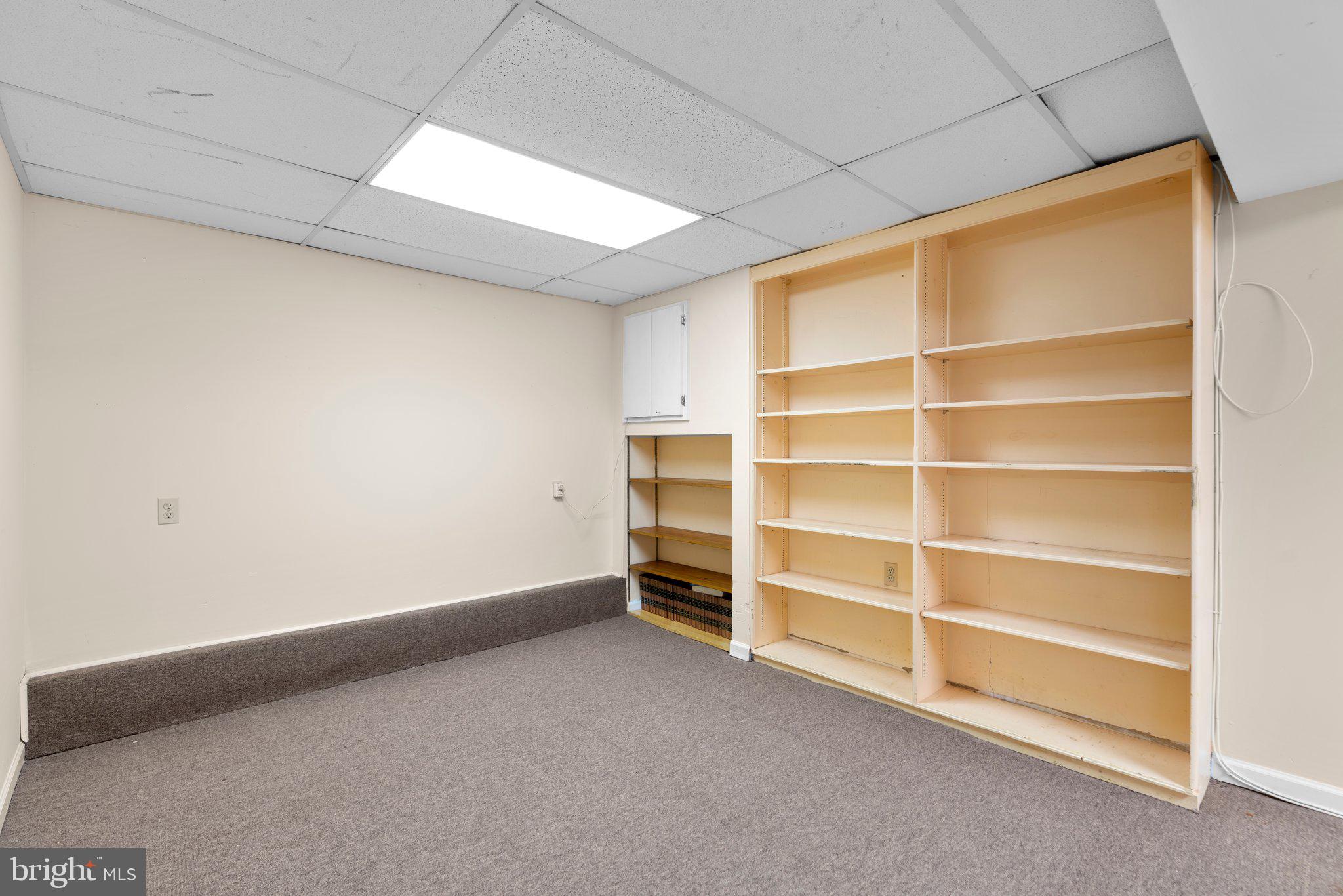 14816 Mistletoe Court Silver Spring, MD 20905 - Photo 30 of 44 a view of an empty room with a fireplace and a window