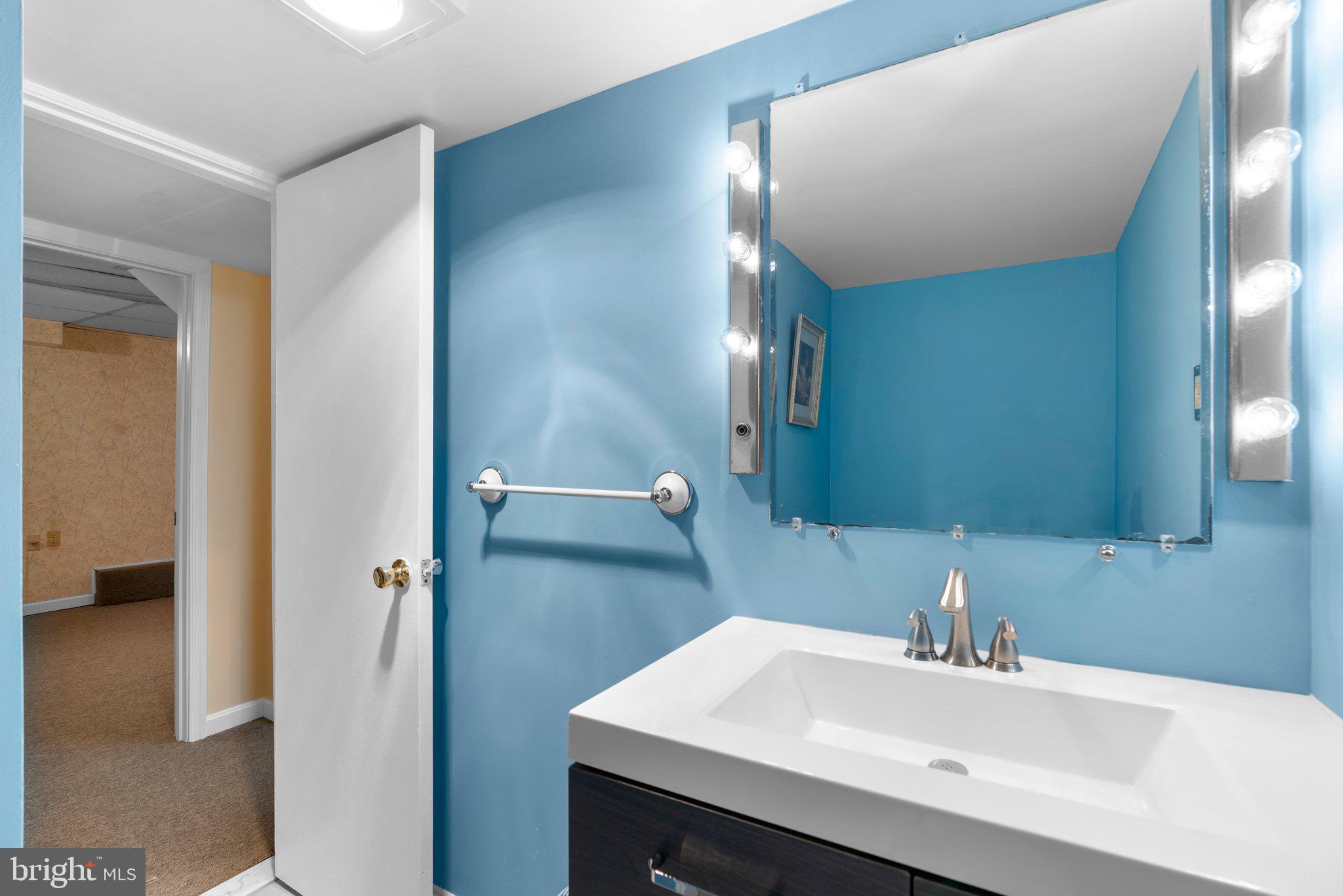 14816 Mistletoe Court Silver Spring, MD 20905 - Photo 37 of 44 a bathroom with a sink and a mirror