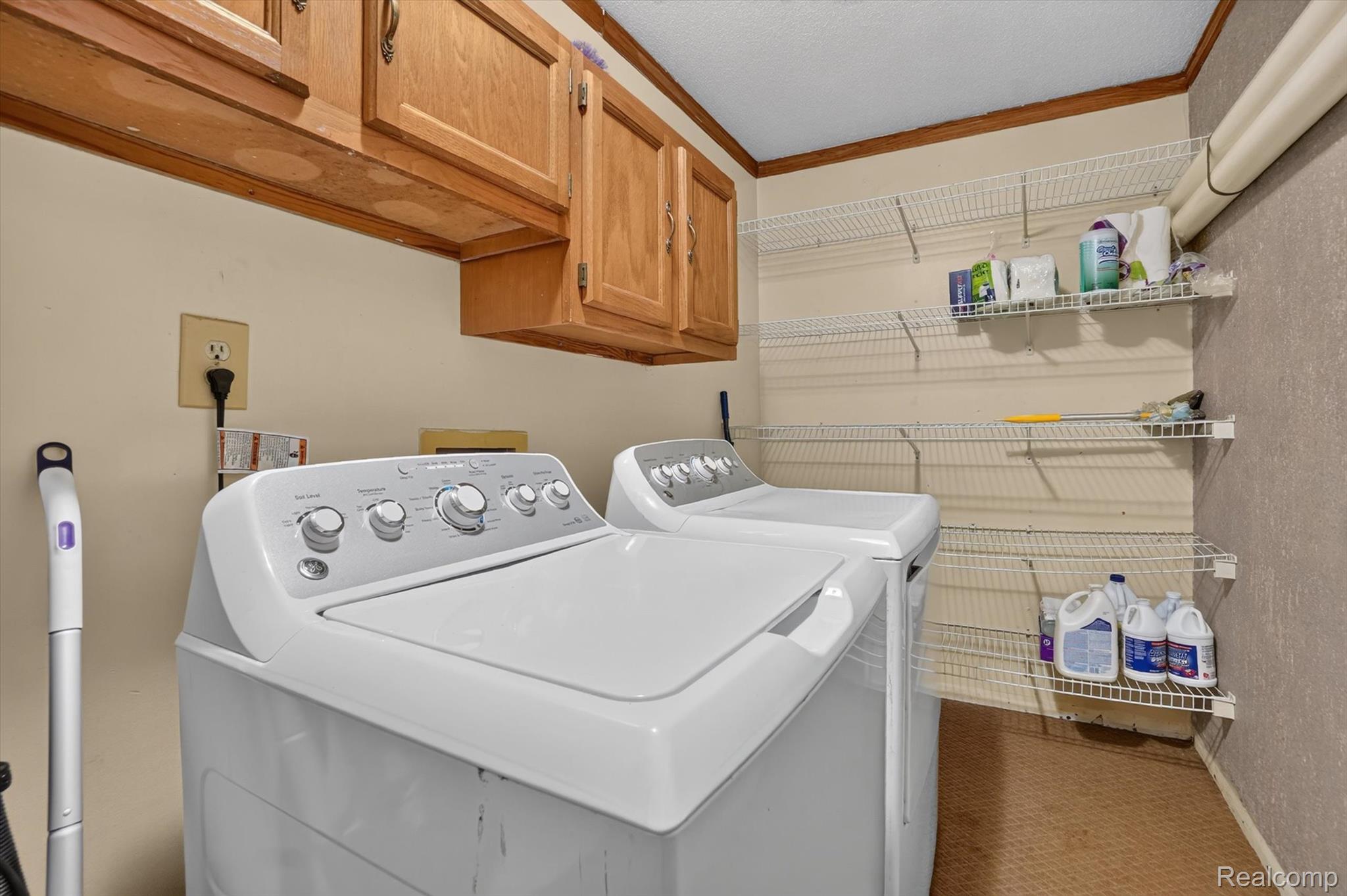 10977 Maple Road Birch Run, MI 48415 - Photo 28 of 49 Upper cabinetry, wall-mounted wire shelving, and textured wall finish