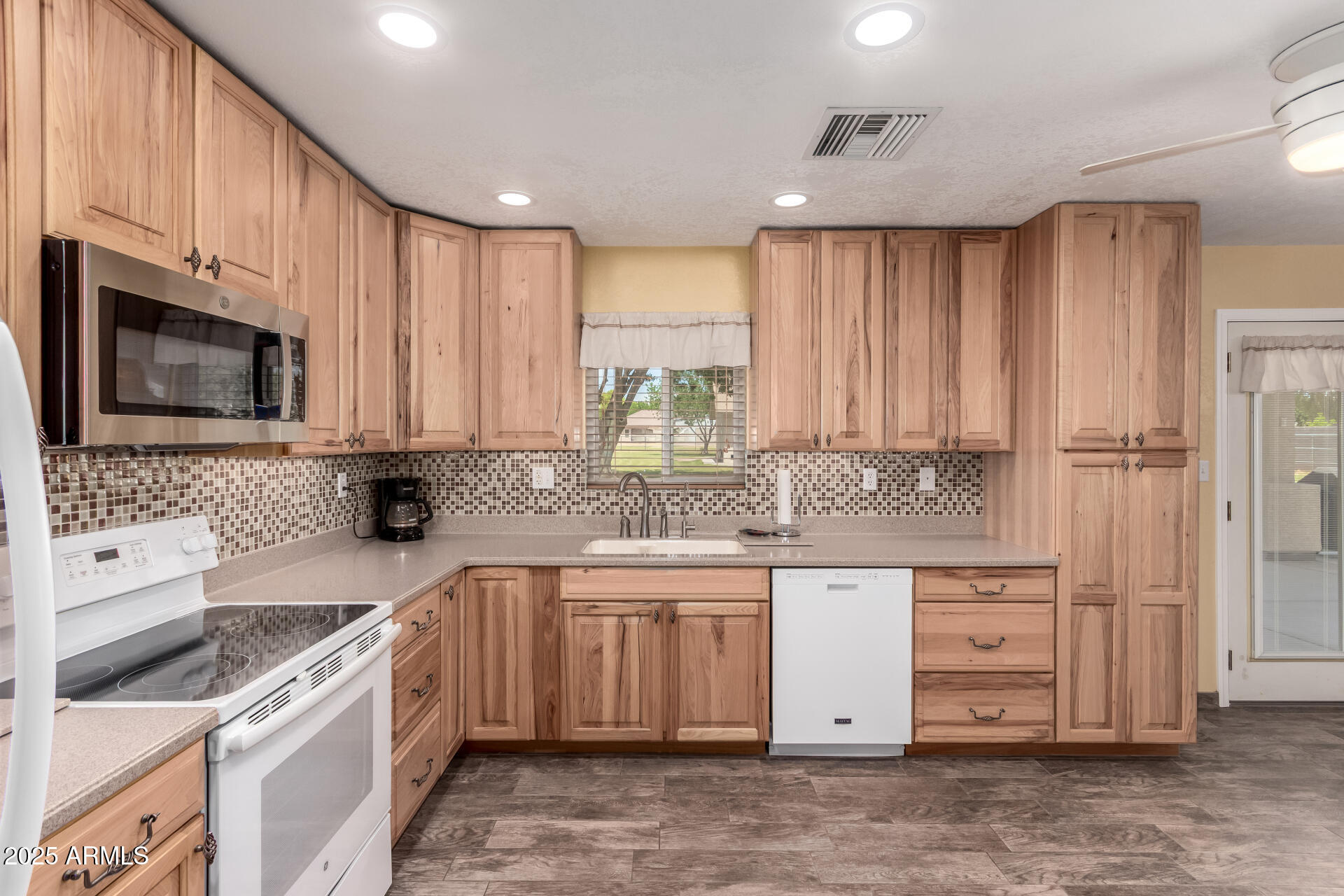 12548 East Cloud Road Chandler, AZ 85249 - Photo 7 of 34 a kitchen with a sink stove top oven and cabinets