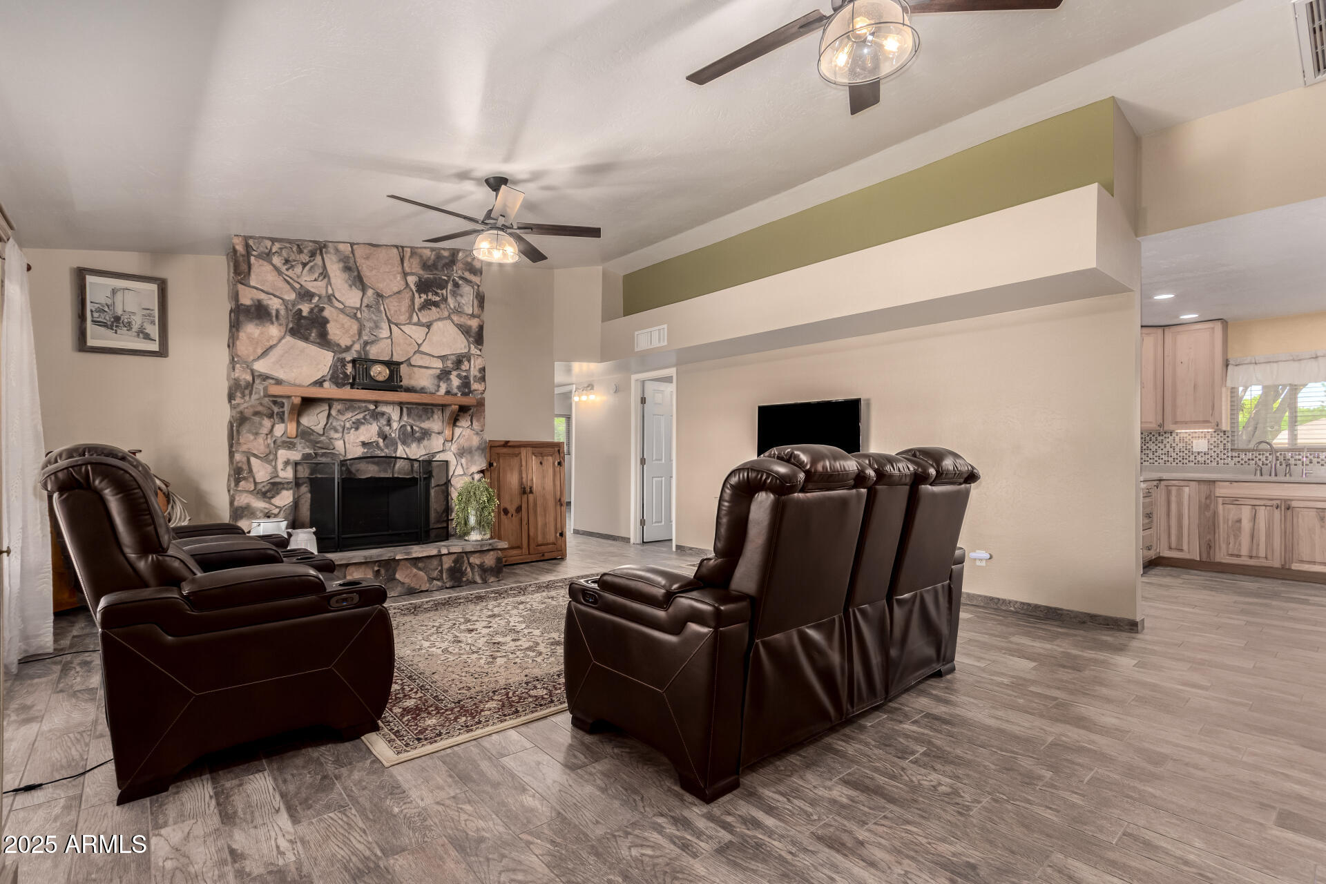 12548 East Cloud Road Chandler, AZ 85249 - Photo 10 of 34 a living room with furniture a fireplace and a flat screen tv