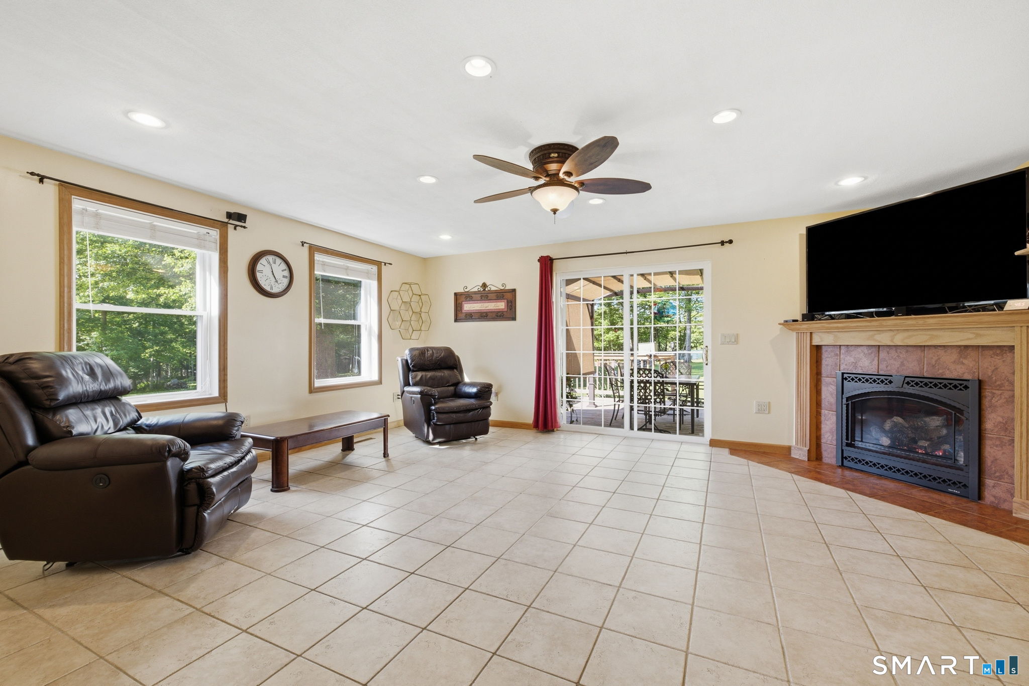 141 Hop River Road Coventry, CT 06238 - Photo 2 of 40 a living room with furniture a flat screen tv and a fireplace