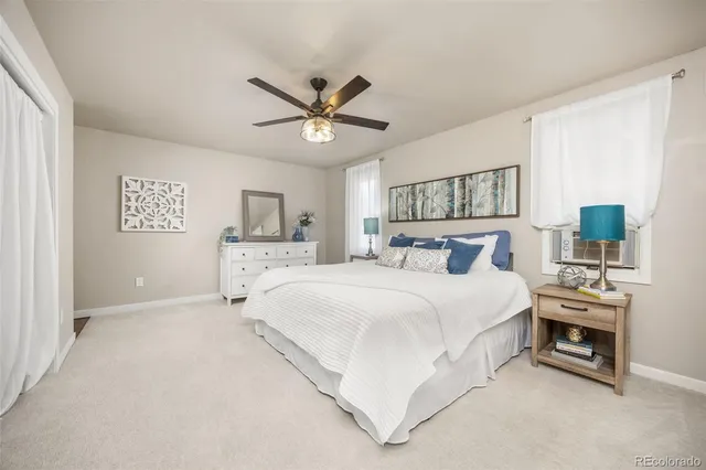 a spacious bedroom with a bed and a chandelier