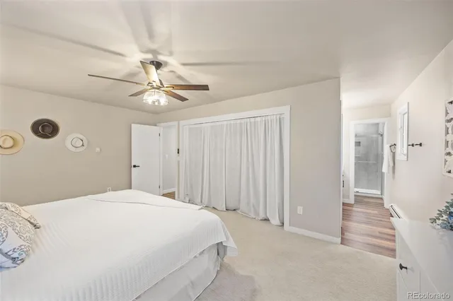a bedroom with a white bed and a chandelier