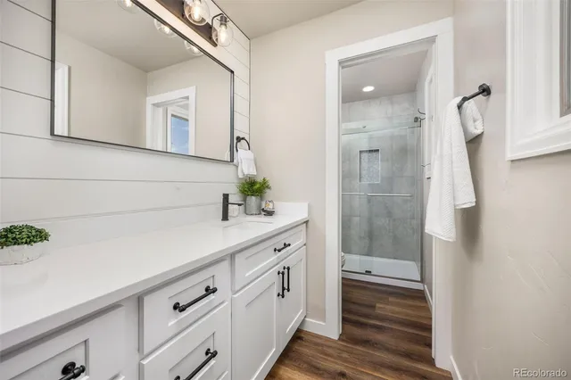 a bathroom with a granite countertop sink and a mirror