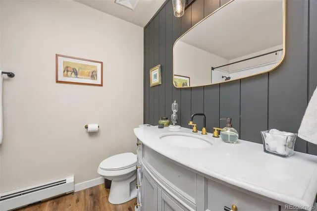 a bathroom with a sink a toilet and mirror