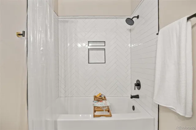 a bathroom with a bathtub and a shower