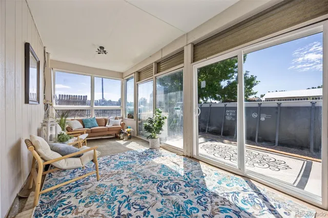 a living room with furniture and a floor to ceiling window