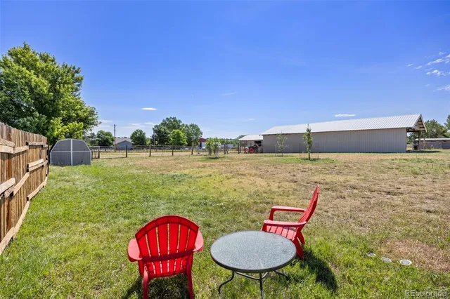 a backyard of a house with yard fire pit and outdoor seating