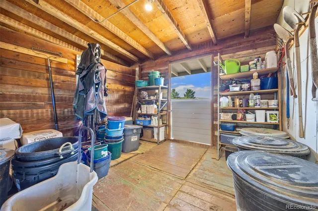 a room with lots of wooden furniture and a shower