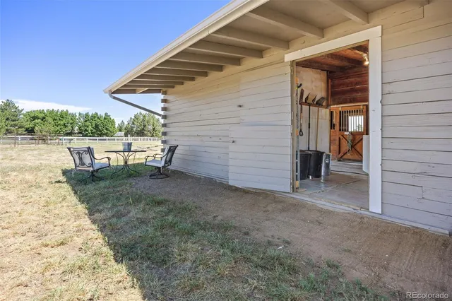 a view of a backyard with chairs